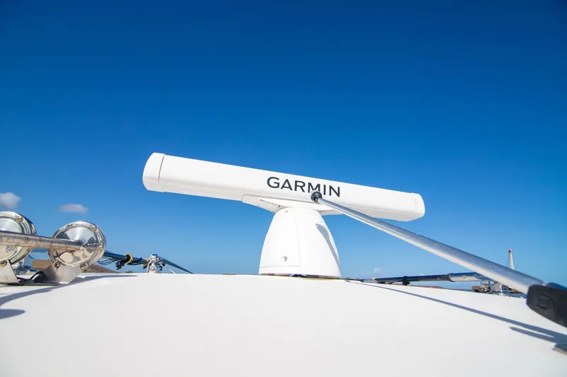 Slide: The Image of 2023 Grady-White Canyon 326 boat with Garmin radar against clear blue sky. - 23