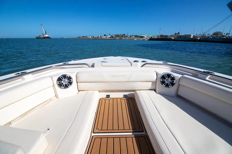 Slide: The Image of 2023 Grady-White Canyon 326 boat interior with cushioned seating and ocean view. - 4