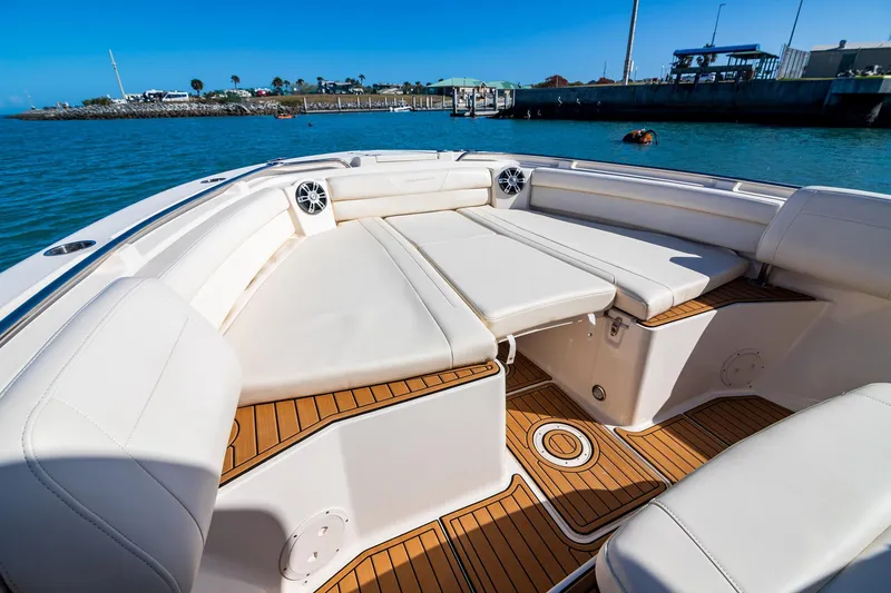 Slide: The Image of 2023 Grady-White Canyon 326 boat interior with luxurious seating and teak flooring. - 5