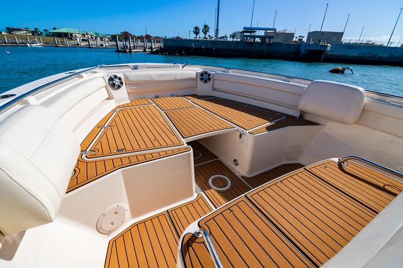 Slide: The Image of 2023 Grady-White Canyon 326 boat interior with teak flooring and white seating. - 6
