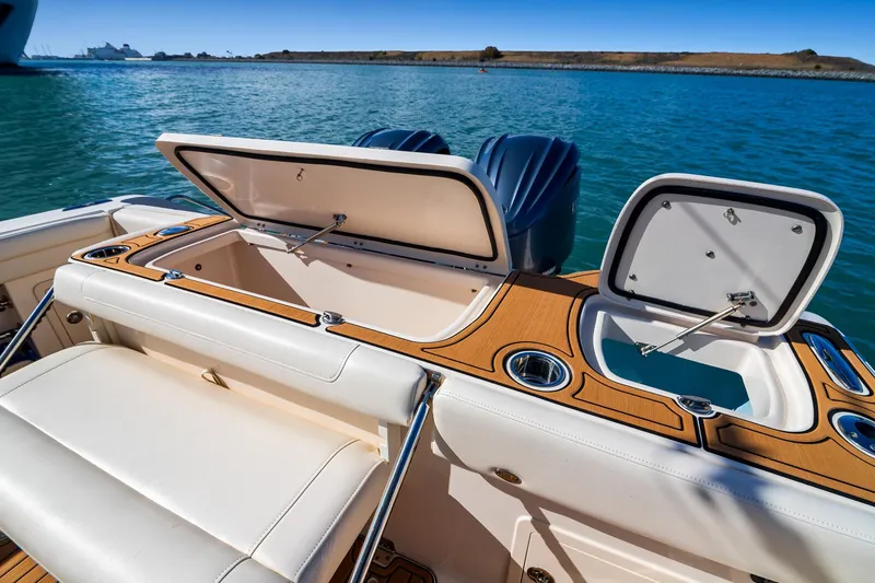 Slide: The Image of 2023 Grady-White Canyon 326 boat with open storage compartments on deck. - 8