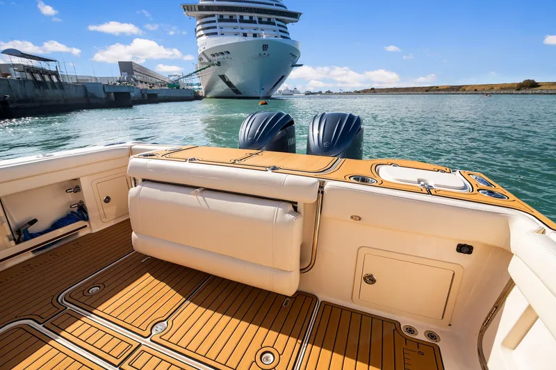 Slide: The Image of 2023 Grady-White Canyon 326 boat interior with cruise ship in background, sunny day. - 9