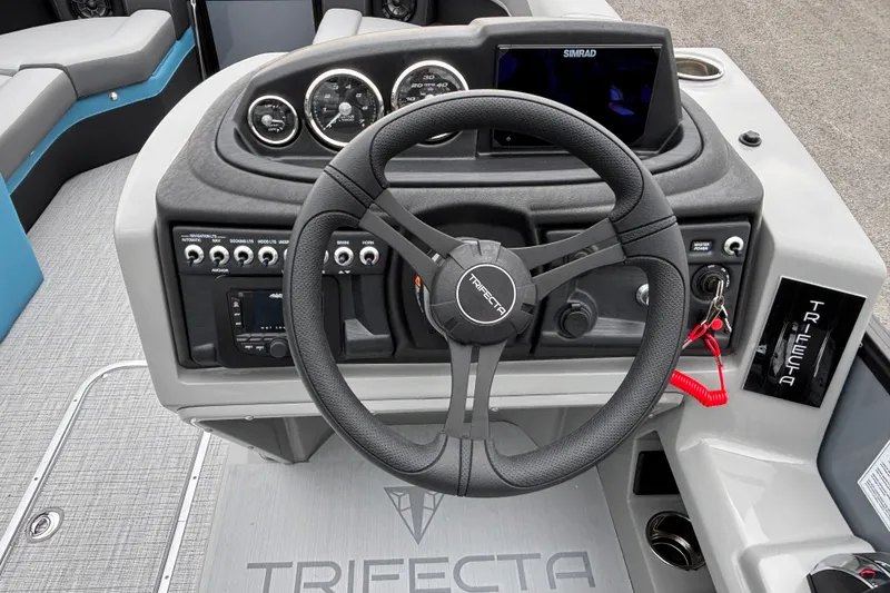 Slide: The Image of 2026 Trifecta C Series 24RFC CS boat dashboard with steering wheel and controls. - 12