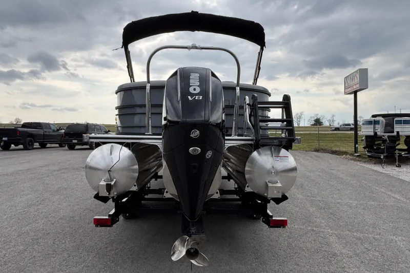 Slide: The Image of 2026 Trifecta C Series 24RFC CS pontoon boat with powerful V8 engine, parked outdoors. - 3