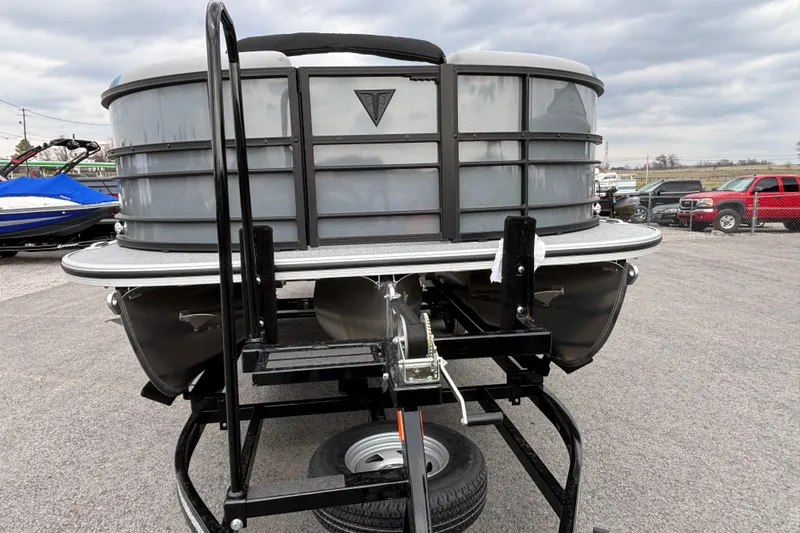 Slide: The Image of 2026 Trifecta C Series 24RFC CS pontoon boat on trailer, overcast sky. - 5