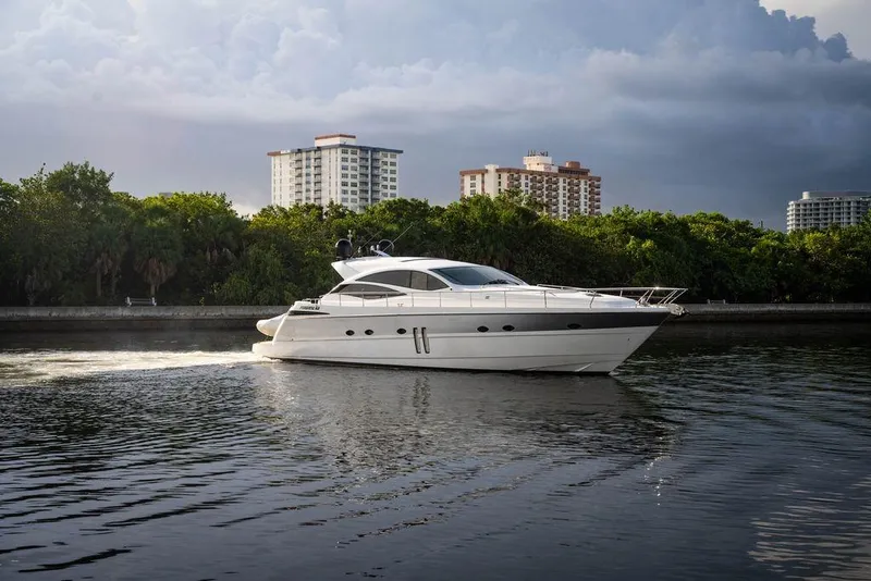 The Image of 2007 Pershing 62' yacht cruising on calm waters near urban skyline. - 0