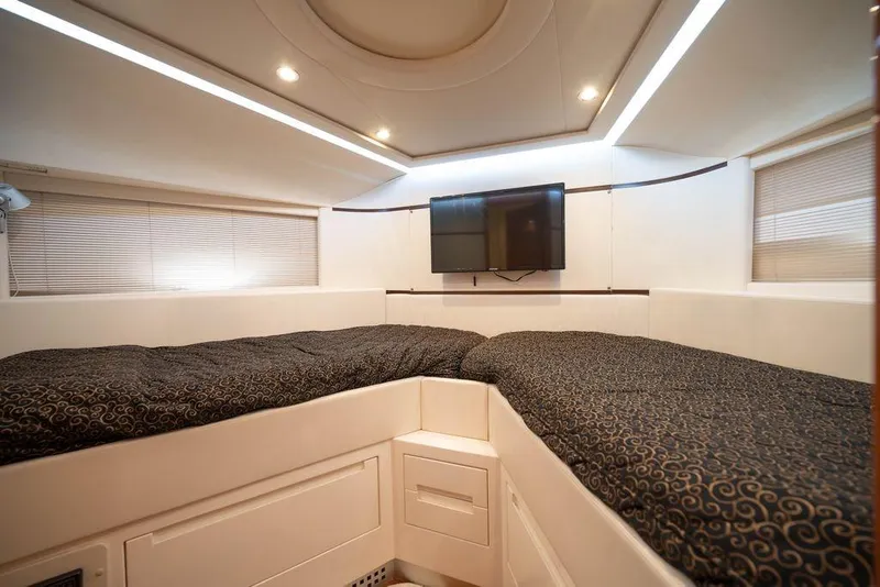 Slide: The Image of Luxurious cabin interior of 2007 Pershing 62' yacht with modern bedding and TV. - 11