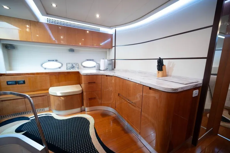 Slide: The Image of Luxurious 2007 Pershing 62' yacht interior with modern kitchen and elegant wood finishes. - 25