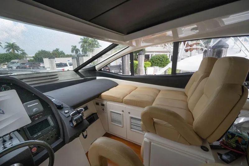 Slide: The Image of Interior of a 2007 Pershing 62' yacht with beige seating and control panel. - 31
