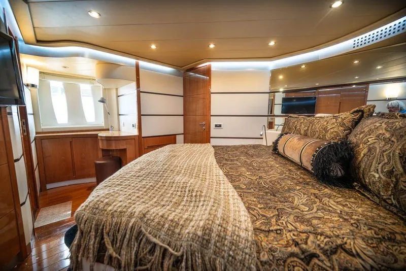 Slide: The Image of Luxurious interior of 2007 Pershing 62' yacht with elegant bedding and wooden accents. - 7