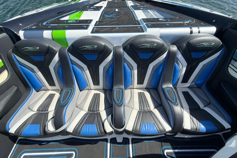 Slide: The Image of Four stylish seats on a 2022 MTI 390X boat with blue and black accents. - 16