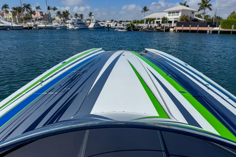 Slide: The Image of 2022 MTI 390X speedboat with vibrant stripes docked in a marina. - 18