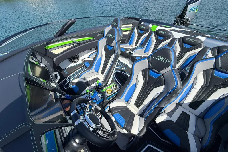 Slide: The Image of Luxurious MTI 390X 2022 boat interior with sleek blue and black seating on water. - 23