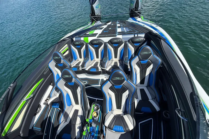 Slide: The Image of Luxury MTI 390X 2022 speedboat interior with blue and black seating on water. - 24