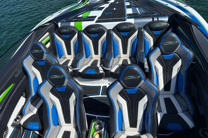 Slide: The Image of 2022 MTI 390X boat interior with blue and black racing seats on water. - 25