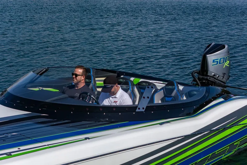 Slide: The Image of 2022 MTI 390X speedboat on water, featuring vibrant green and blue accents. - 32