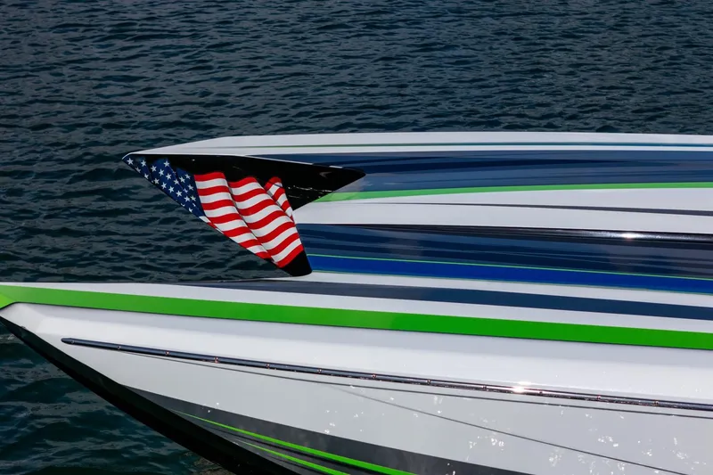 Slide: The Image of 2022 MTI 390X speedboat with American flag, sleek design on water. - 33