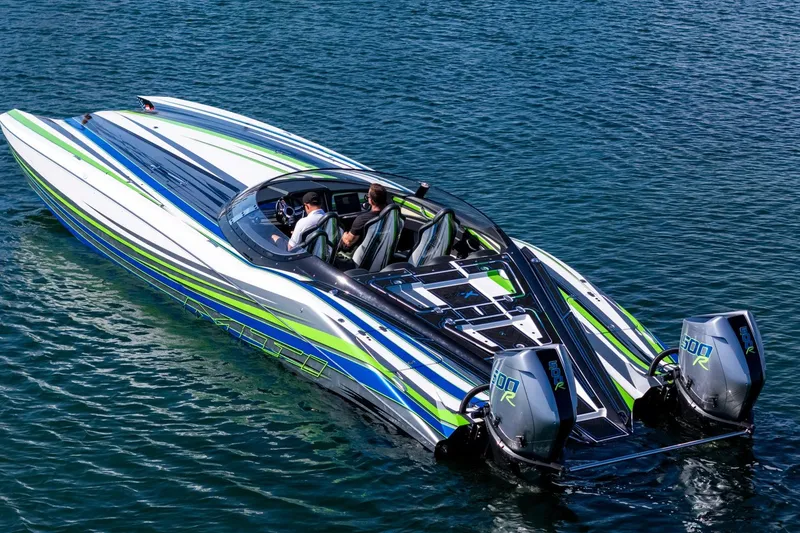 Slide: The Image of 2022 MTI 390X speedboat with vibrant stripes, cruising on clear blue water. - 36