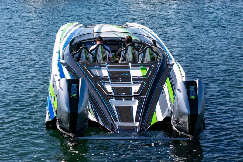 Slide: The Image of 2022 MTI 390X powerboat with vibrant design on calm water. - 39