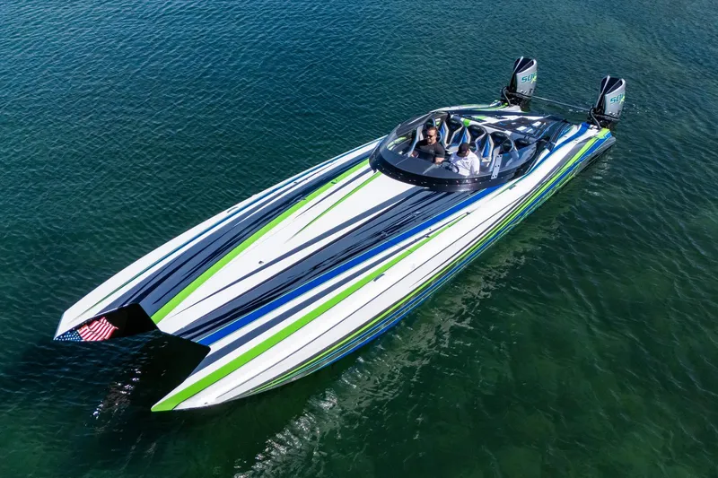 Slide: The Image of 2022 MTI 390X speedboat with vibrant stripes on clear water. - 4