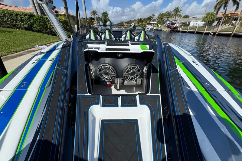 Slide: The Image of 2022 MTI 390X powerboat with vibrant design on calm water. - 40