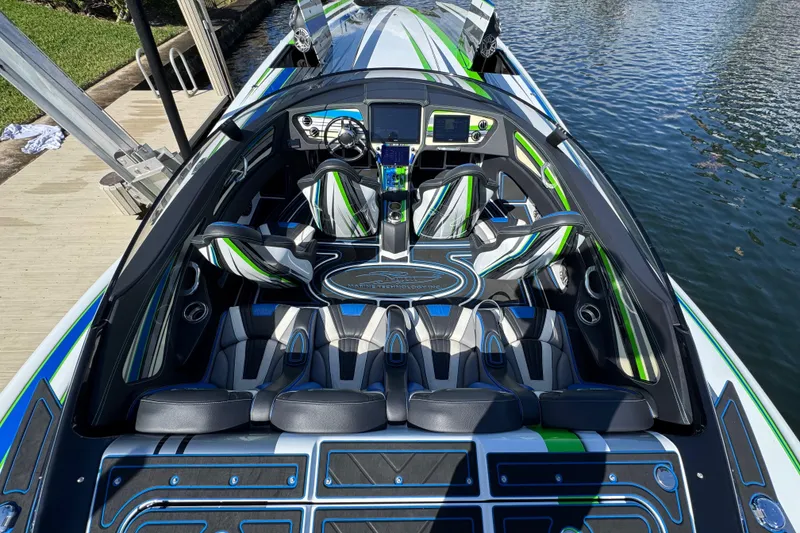 Slide: The Image of 2022 MTI 390X boat with open hatch revealing speakers, dockside view. - 42