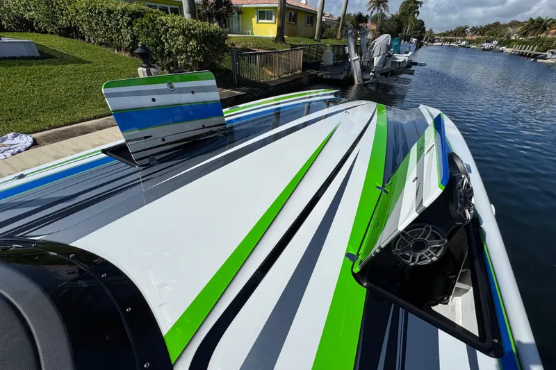 Slide: The Image of Interior of a 2022 MTI 390X boat with sleek, modern design and vibrant seating. - 43