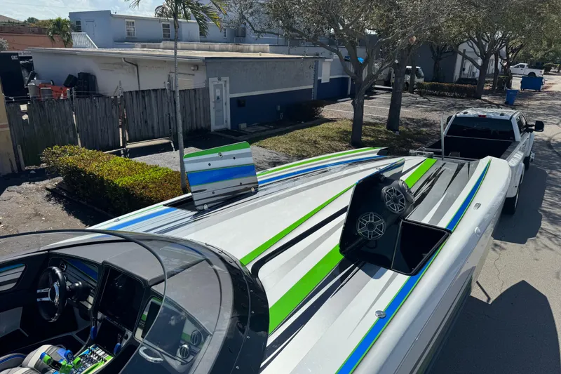 Slide: The Image of 2022 MTI 390X boat with open hatch revealing speakers, set against a sunny backdrop. - 46