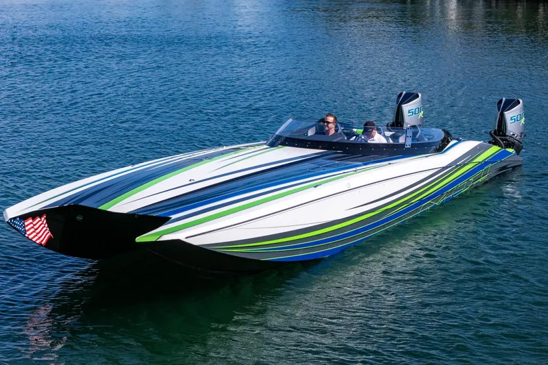 Slide: The Image of 2022 MTI 390X speedboat with vibrant stripes on a calm blue lake. - 5