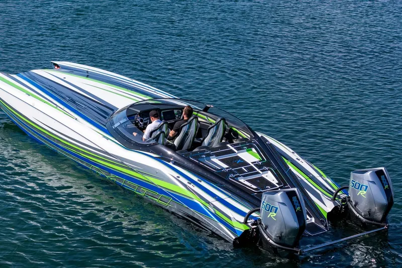 Slide: The Image of 2022 MTI 390X speedboat with vibrant stripes on calm water. - 6