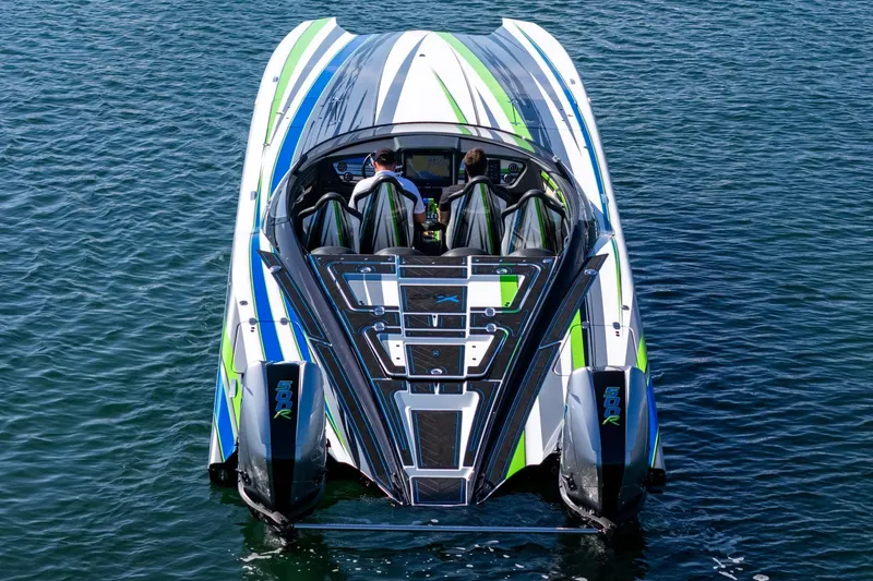 Slide: The Image of 2022 MTI 390X powerboat with vibrant green and blue accents on the water. - 7