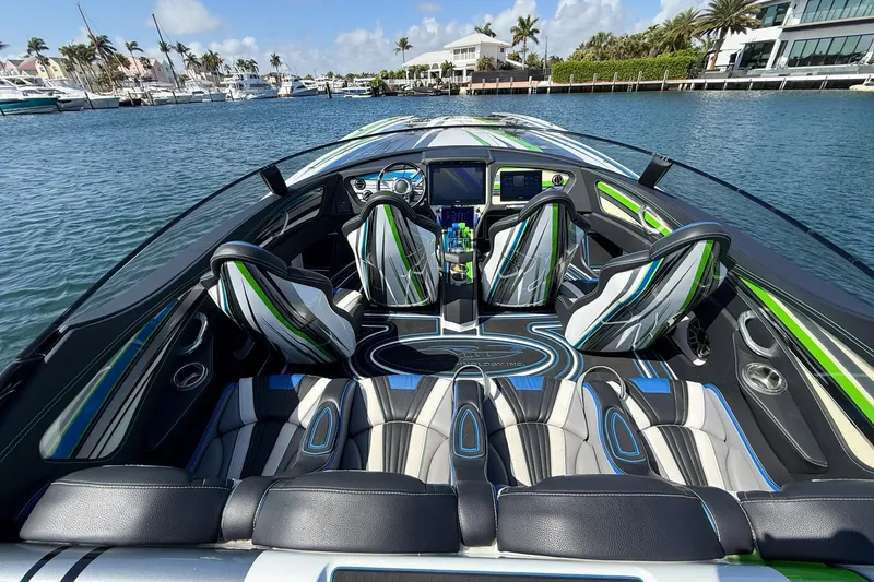 Slide: The Image of Luxury MTI 390X 2022 speedboat interior with stylish seating and dashboard, docked in a marina. - 8