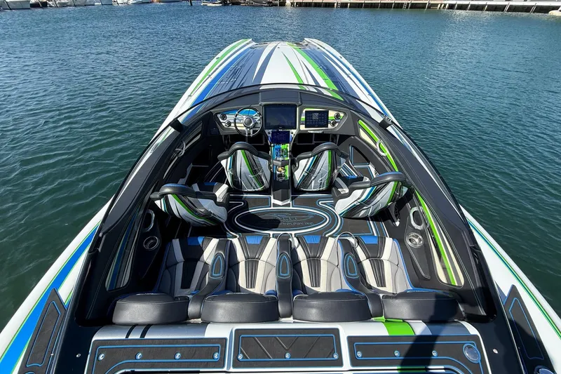 Slide: The Image of 2022 MTI 390X speedboat interior with sleek design and vibrant green accents. - 9