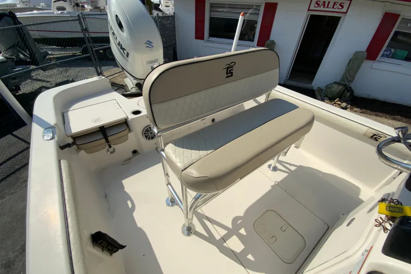 Slide: The Image of 2021 Carolina Skiff 21 LS boat interior with seating and Suzuki outboard motor. - 20