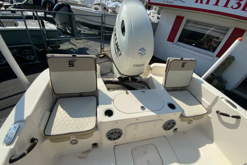 Slide: The Image of 2021 Carolina Skiff 21 LS boat interior with Suzuki 150 engine and cushioned seating. - 23