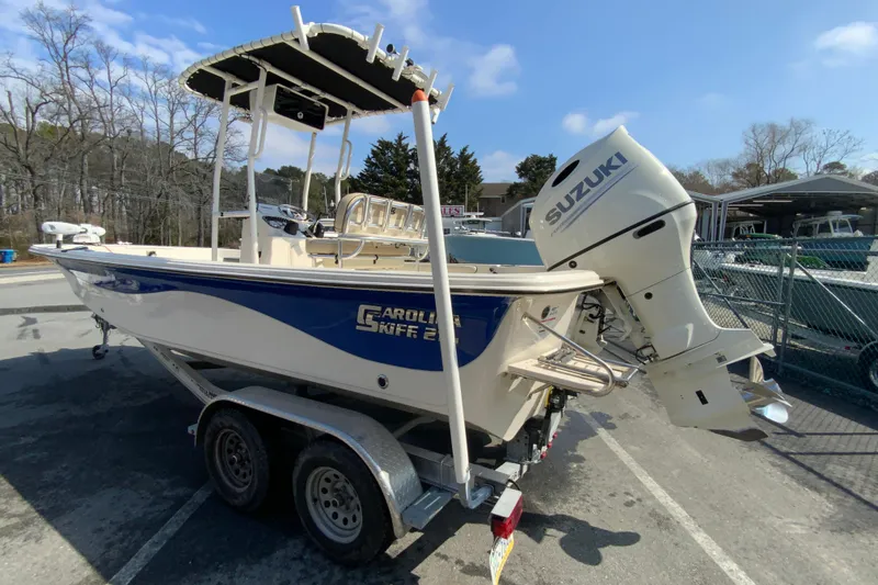 Slide: The Image of 2021 Carolina Skiff 21 LS boat with Suzuki outboard motor on trailer. - 7