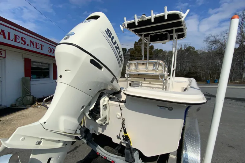Slide: The Image of 2021 Carolina Skiff 21 LS boat with Suzuki outboard motor, parked outdoors. - 9