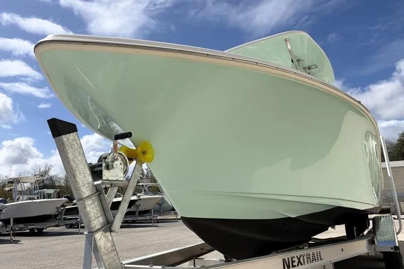 Slide: The Image of 2024 Key West 239 FS boat on trailer under blue sky. - 10