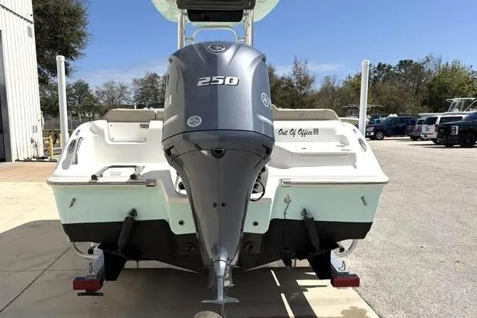 Slide: The Image of 2024 Key West 239 FS boat with Yamaha 250 engine, parked outdoors. - 11