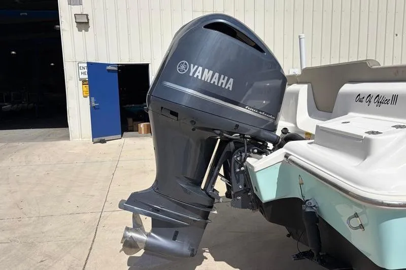 Slide: The Image of 2024 Key West 239 FS boat with Yamaha outboard motor in a marina setting. - 14