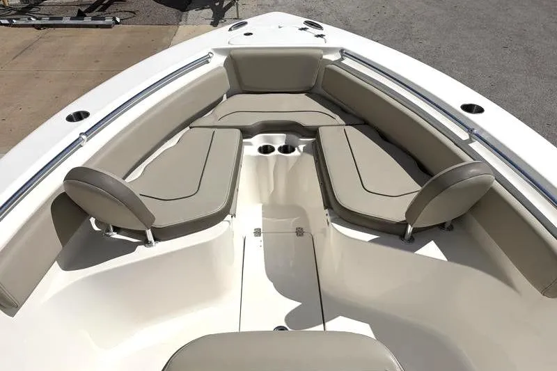 Slide: The Image of 2024 Key West 239 FS boat interior with cushioned seating and cup holders. - 16