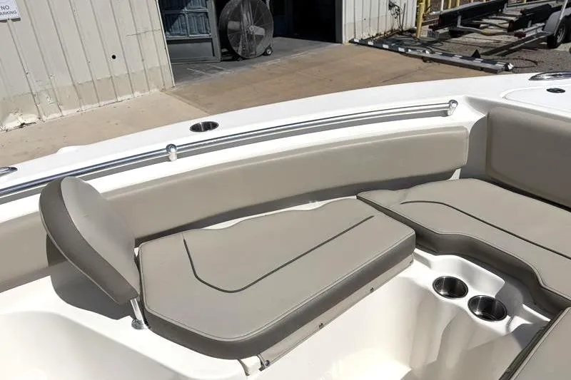 Slide: The Image of 2024 Key West 239 FS boat interior with cushioned seating and cup holders. - 17