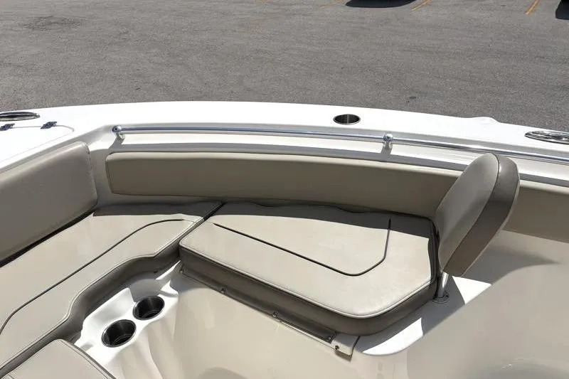 Slide: The Image of 2024 Key West 239 FS boat interior with beige seating and cup holders. - 18