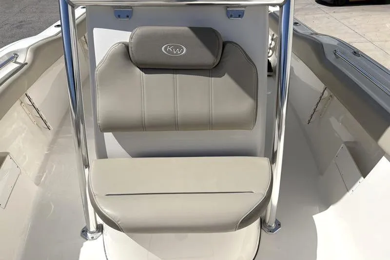 Slide: The Image of 2024 Key West 239 FS boat seating area with beige cushions and stainless steel frame. - 20