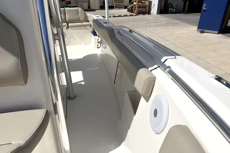 Slide: The Image of 2024 Key West 239 FS boat interior with beige seating and speaker. - 22