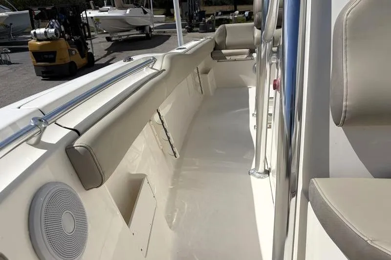 Slide: The Image of 2024 Key West 239 FS boat interior with beige seating and stainless steel railings. - 23