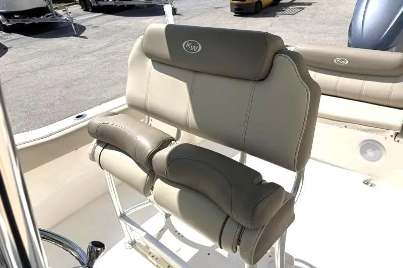 Slide: The Image of 2024 Key West 239 FS boat seating with beige upholstery and KW logo. - 24