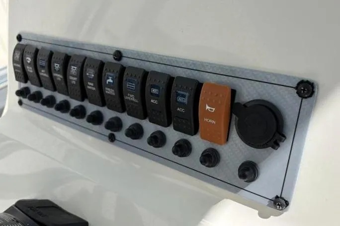 Slide: The Image of Control panel of 2024 Key West 239 FS boat with labeled switches and buttons. - 28