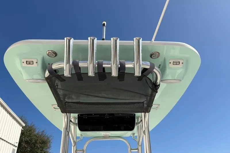 Slide: The Image of 2024 Key West 239 FS boat T-top with rod holders against clear blue sky. - 35