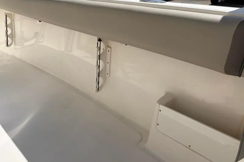 Slide: The Image of 2024 Key West 239 FS boat interior detail with storage compartments and cushioned seating. - 36